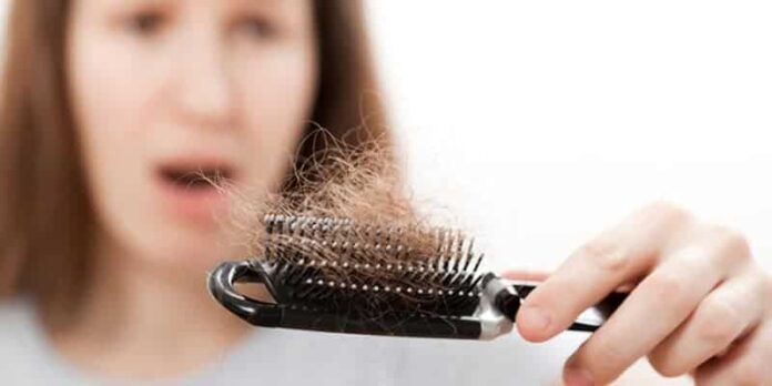 Women holding a brush containing a large amount of hair