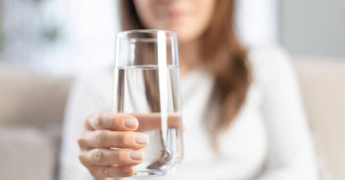 Woman holding a glass of water