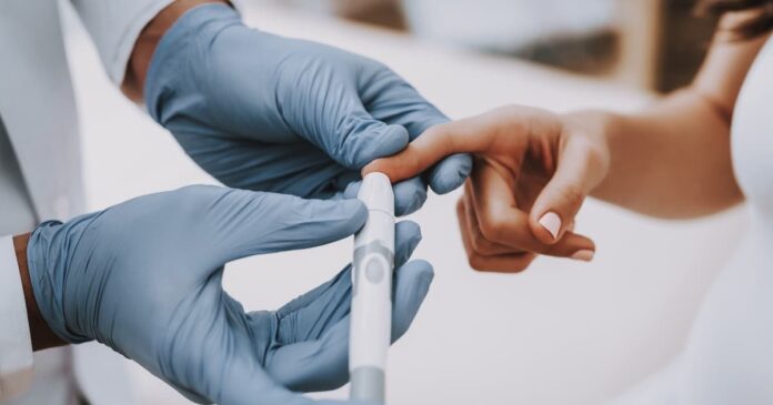 Image of doctor pricking a patient