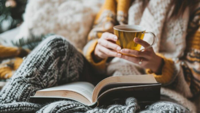 Woman drinking tea in bed.